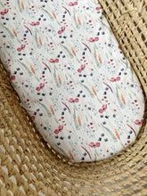 Load image into Gallery viewer, Baby moses basket with poppy and foliage print sheet on mattress
