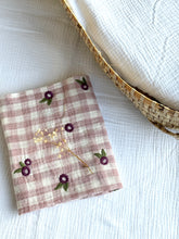 Load image into Gallery viewer, Checkered baby muslin burp cloth with floral embroidery on a white surface
